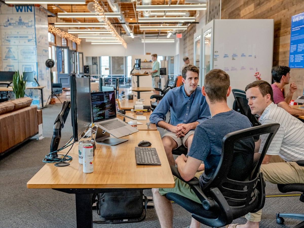 Colleagues discussing the next priority in a modern professional workspace